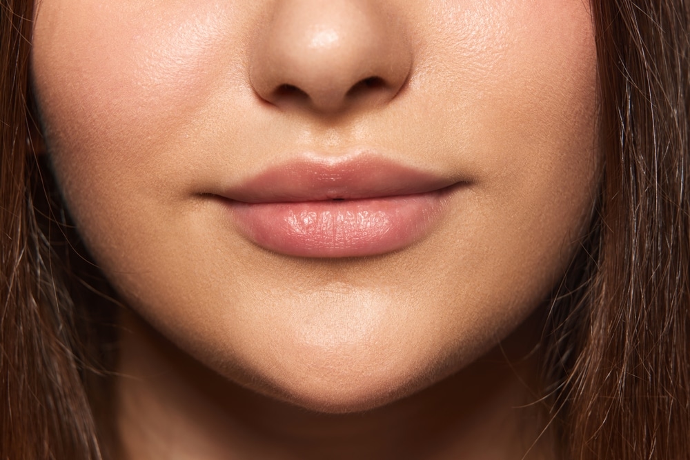 Close up of a woman's full, soft, smooth lips after getting treatment to remove venous lakes.