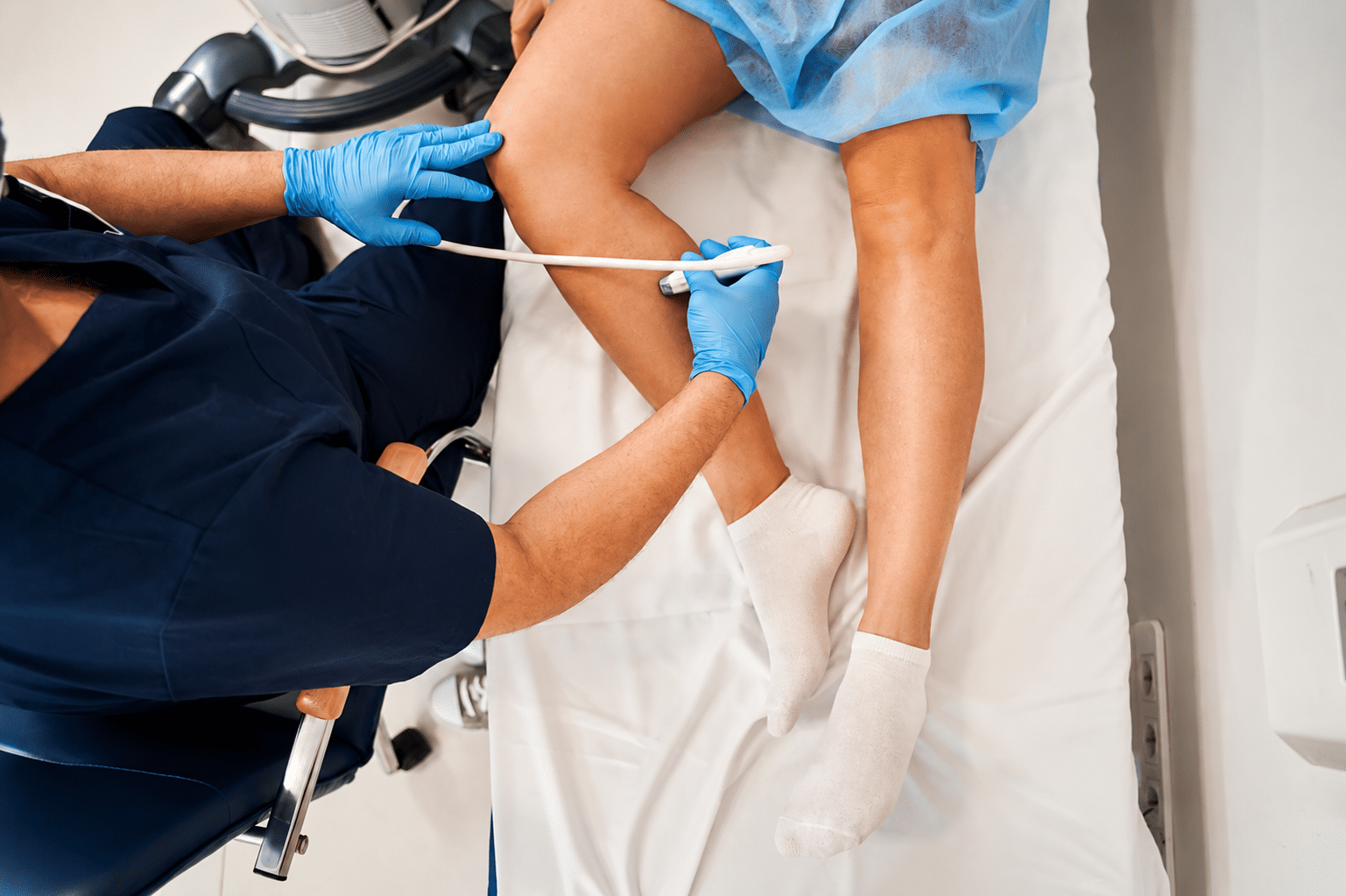 Top down of a patient having their leg veins mapped using ultrasound to help with vein treatment planning.